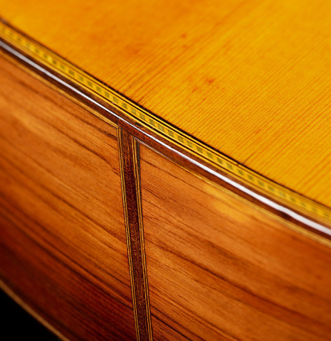 The top binding and purflings of a 1918 Enrique Garcia classical guitar made of spruce and CSA rosewood