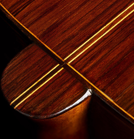 The heel, back binding and purfling of a 1918 Enrique Garcia classical guitar made of spruce and CSA rosewood