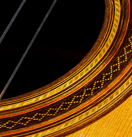 Closeup detail of the rosette of a 1918 Enrique Garcia classical guitar made of spruce and CSA rosewood