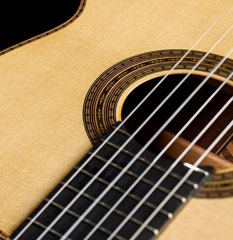 The soundboard, fingerboard and rosette of a 2023 Francisco Navarro Garcia classical guitar made of spruce and Indian rosewood