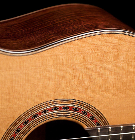 The rosette and side of a 2022 Michel Belair &quot;Hommage a Daniel Friederich&quot; classical guitar made of cedar and Indian rosewood