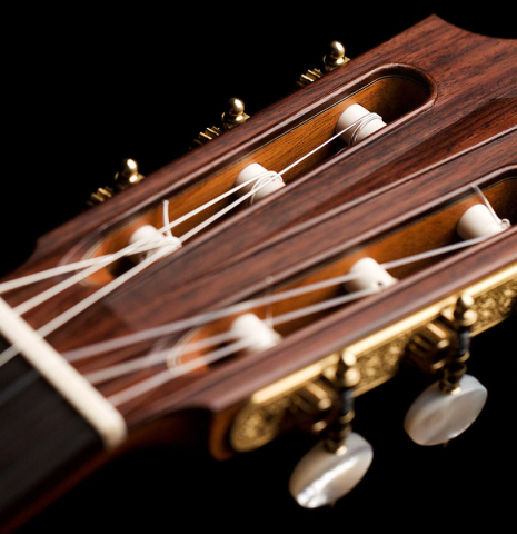 The headstock of a 2022 Michel Belair &quot;Hommage a Daniel Friederich&quot; classical guitar made of cedar and Indian rosewood