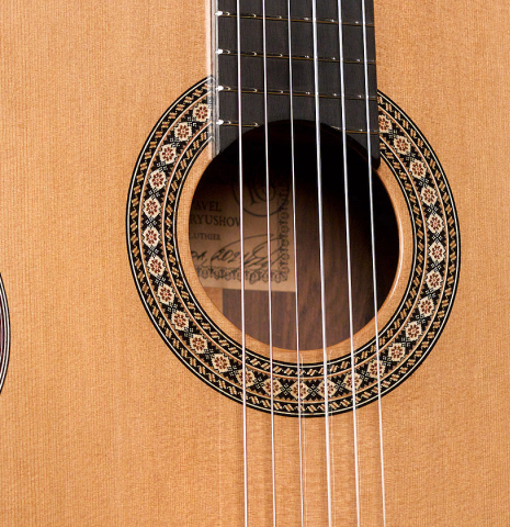 The soundboard and rosette of a 2021 Pavel Gavryushov classical guitar made of cedar and African rosewood