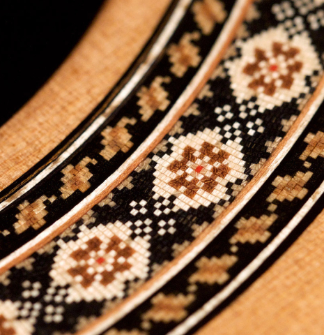 A close-up of the rosette of a 2021 Pavel Gavryushov classical guitar made of cedar and African rosewood