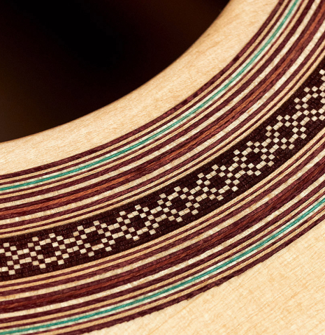 A close-up of the rosette of a 2023 Pavel Gavryushov classical guitar made of spruce and Indian rosewood