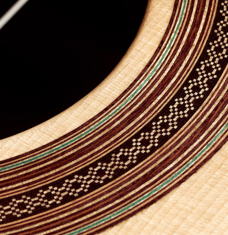 A close-up of the rosette of a 2023 Pavel Gavryushov classical guitar made of spruce and African rosewood