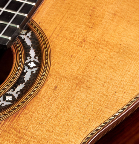 The rosette and soundboard of a 1900's Casa Gonzalez classical guitar made of spruce and CSA rosewood