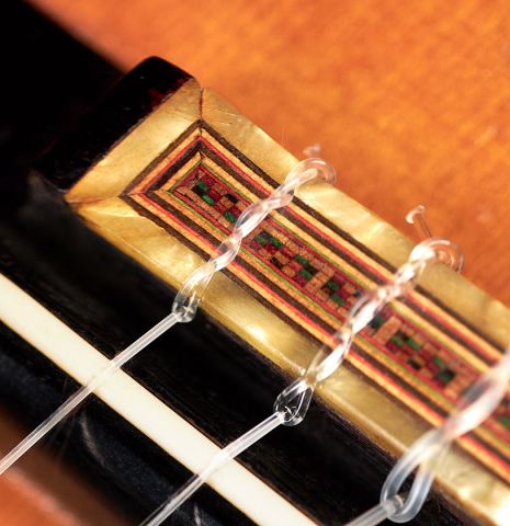 The ornamented bridge of a 1947 Diego y Gracia classical guitar made of spruce and CSA rosewood