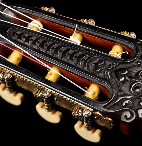 The carved headstock of a 1947 Diego y Gracia classical guitar made of spruce and CSA rosewood