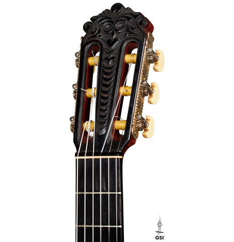 The carved headstock of a 1947 Diego y Gracia classical guitar made of spruce and CSA rosewood