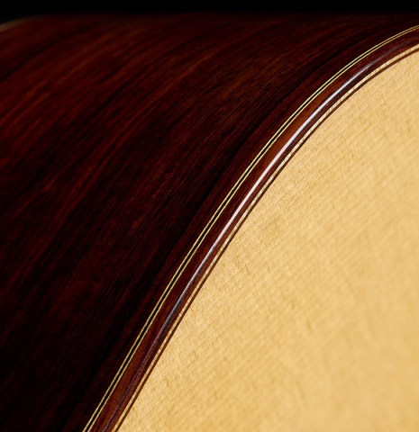 The top binding and purfling of a 2025 Mario Grimaldi "1920 Santos" classical guitar made of spruce and African rosewood