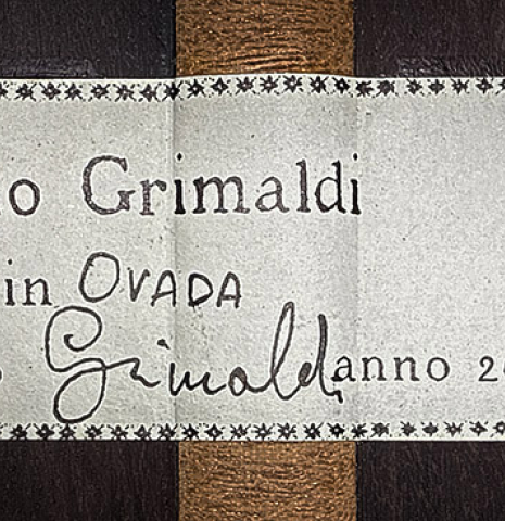 The label of a 2025 Mario Grimaldi "1920 Santos" classical guitar made of spruce and African rosewood