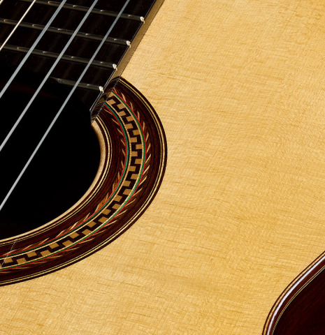 The soundboard and rosette of a 2025 Mario Grimaldi "1920 Santos" classical guitar made of spruce and African rosewood