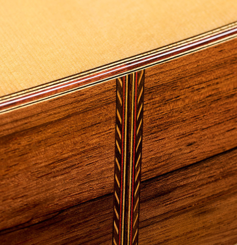 The foot where the sides meet with purfling of a 2026 Mario Grimaldi "1920 Santos" classical guitar made of spruce and African rosewood