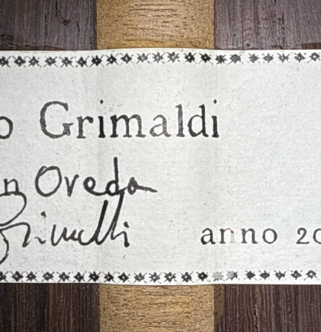 The label of a 2026 Mario Grimaldi "1920 Santos" classical guitar made of spruce and African rosewood