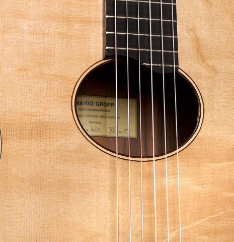 The soundboard and oval rosette of a 2019 Mario Gropp "Weissgerber" made of spruce and exotic ebony