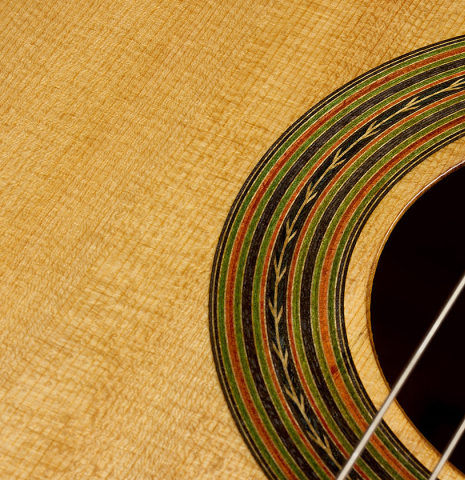 The soundboard and rosette detail of a 2025 Yulong Guo "Torres SE 124" classical guitar made of spruce and maple