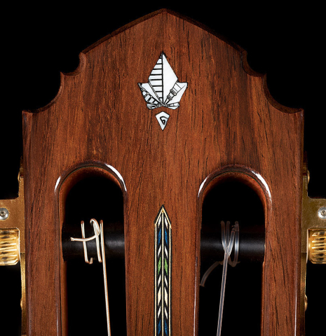 The headstock with fleur-de-lis inlay of a 2023 Miguel Angel Gutierrez classical guitar made of spruce and Indian rosewood.