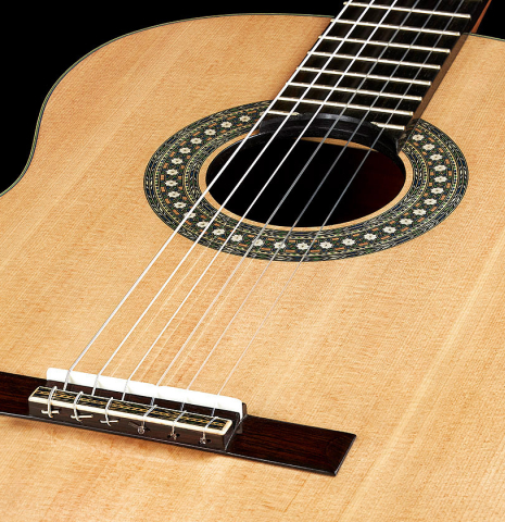 The soundboard of a 2023 Miguel Angel Gutierrez classical guitar made of spruce and Indian rosewood.
