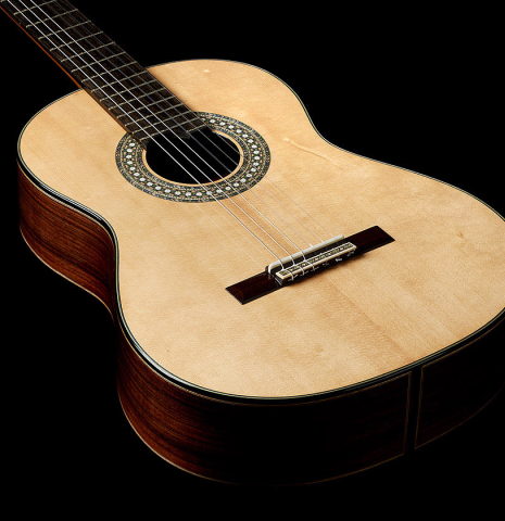 The soundboard of a 2024 Miguel Angel Gutierrez classical guitar made of spruce and Indian rosewood.
