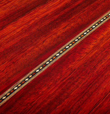 The back center seam of a 2025 Miguel Angel Gutierrez "REG 2025" classical guitar made of cedar and padauk