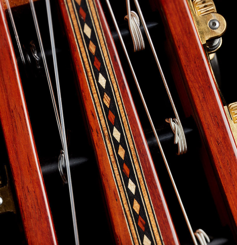The inlays in the headstock veneer of a 2025 Miguel Angel Gutierrez "REG 2025" classical guitar made of cedar and padauk