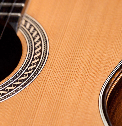 The soundboard and rosette of a 2021 Henner Hagenlocher classical guitar made with cedar and CSA rosewood