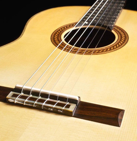 The soundboard and bridge of a 2015 Henner Hagenlocher made with spruce top and CSA rosewood back and sides