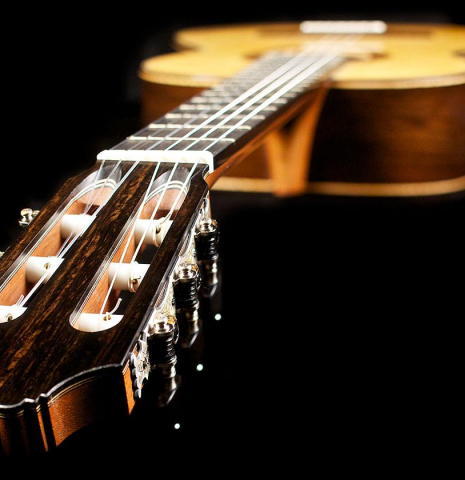 The headstock and machine heads of a 2015 Henner Hagenlocher made with spruce top and CSA rosewood back and sides