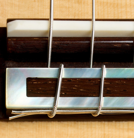 The bridge, tie-block and saddle of a 2026 Henner Hagenlocher classical guitar made of spruce and CSA rosewood