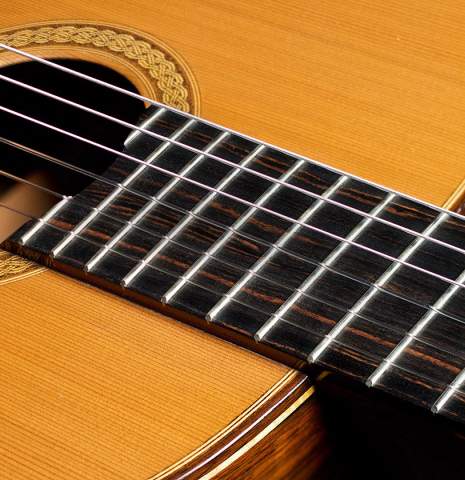 The fretboard of a 2008 Henner Hagenlocher classical guitar made of cedar and CSA rosewood