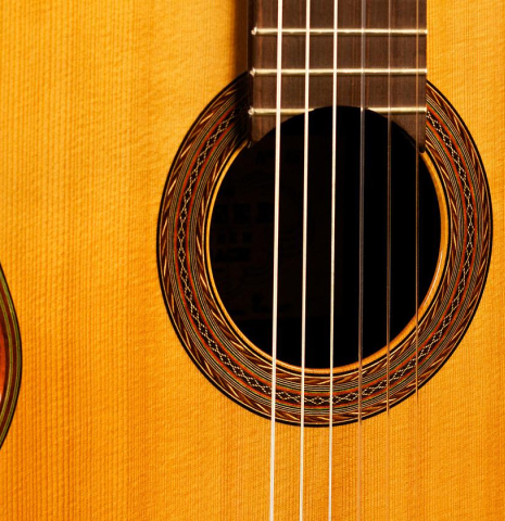 The top and rosette detail of a 1986 Hermann Hauser III classical guitar made of spruce and CSA rosewood