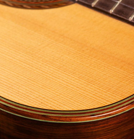The top binding and purfling of a 1986 Hermann Hauser III classical guitar made of spruce and CSA rosewood