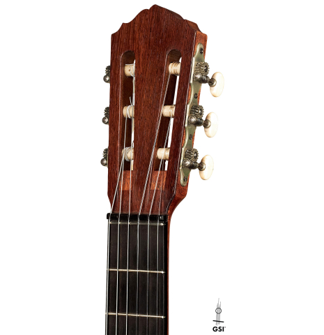 This is the headstock of a 1927 Hermann Hauser I classical guitar made with spruce for the soundboard and maple for the back and sides on a white background.