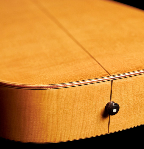 This is the back and sides at the foot, including endpin of a 1927 Hermann Hauser I classical guitar made with spruce for the soundboard and maple for the back and sides.