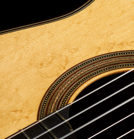 The soundboard and rosette of a 2013 Hermann Hauser III "Llobet" classical guitar made of spruce and CSA rosewood