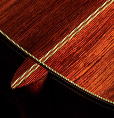 The heel and back purflings of a 2010 Hermann Hauser III classical guitar made of spruce and CSA rosewood
