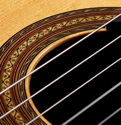 Detailed close-up of the rosette of a 2010 Hermann Hauser III classical guitar made of spruce and CSA rosewood