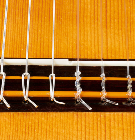 The bridge, tie-block and saddle of a 1976 Hermann Hauser II classical guitar made of spruce and Indian rosewood