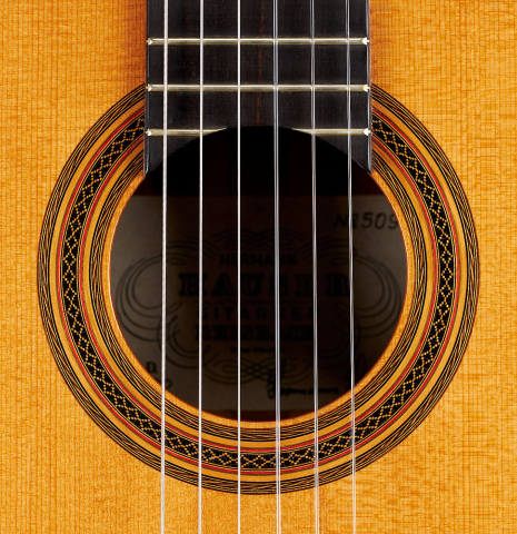 The rosette of a 2002 Hermann Hauser III classical guitar made of spruce and pau ferro