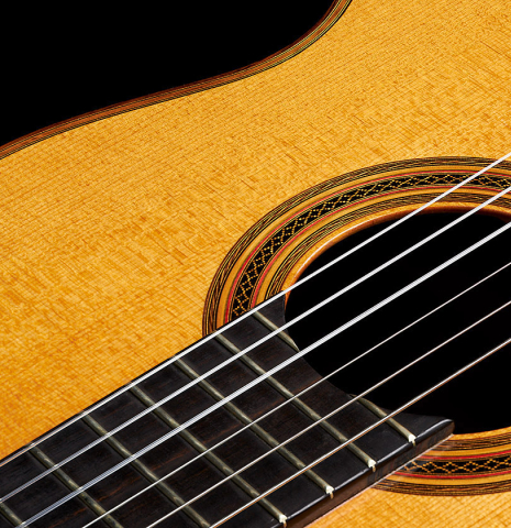 The top and rosette detail of a 2002 Hermann Hauser III classical guitar made of spruce and pau ferro