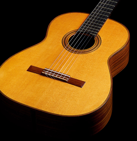 The soundboard of a 2002 Hermann Hauser III classical guitar made of spruce and pau ferro