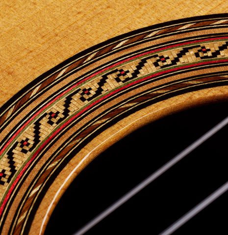 Closeup detail of the rosette of a 2000 Hermann Hauser III classical guitar made of spruce and CSA rosewood