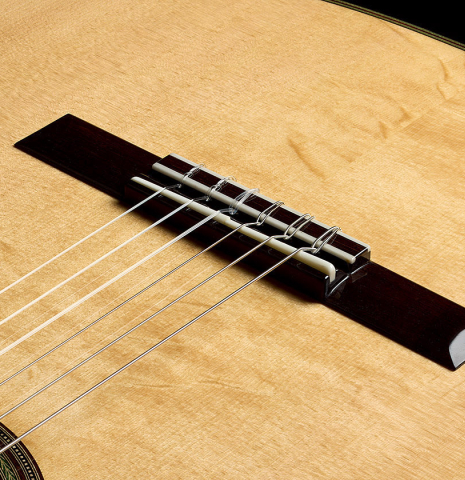 The top, bridge, tie-block and saddle of a 2022 Kathrin Hauser "Segovia" classical guitar made of spruce and CSA rosewood