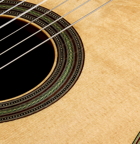 The soundboard and rosette detail of a 2022 Kathrin Hauser "Segovia" classical guitar made of spruce and CSA rosewood