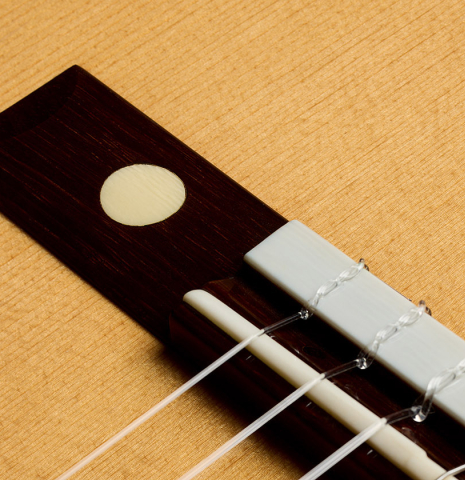 The bridge, mother-of-pearl inlay, tie-block and saddle of a 2004 Hermann Hauser III "1931 Segovia" classical guitar (ex Marcelo Kayath) made of spruce and CSA rosewood