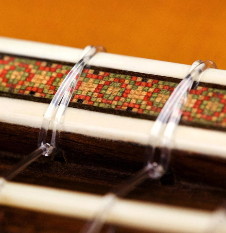 The bridge, tie-block and saddle of a 1966 Hernandez y Aguado classical guitar made of spruce and CSA rosewood