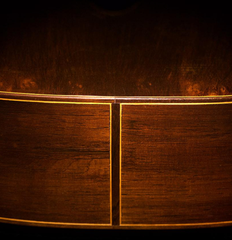 The sides at the foot of a 1966 Hernandez y Aguado classical guitar made of spruce and CSA rosewood