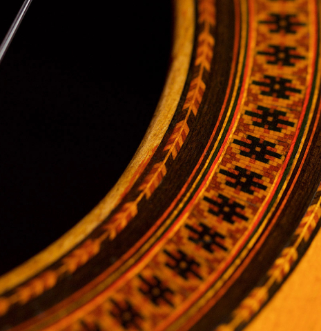 A close-up of the rosette of a 1965 Hernandez y Aguado classical guitar made with spruce and Indian rosewood