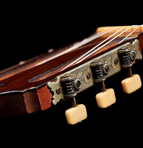The machine heads of a 1918 Santos Hernandez classical guitar made with spruce and csa rosewood